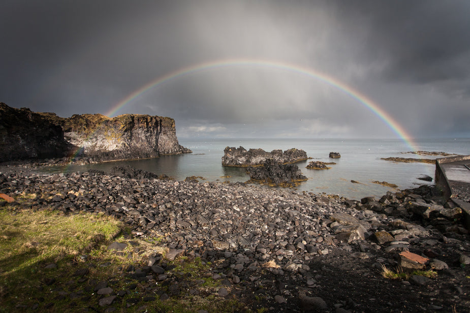 rainbow over rocks and water